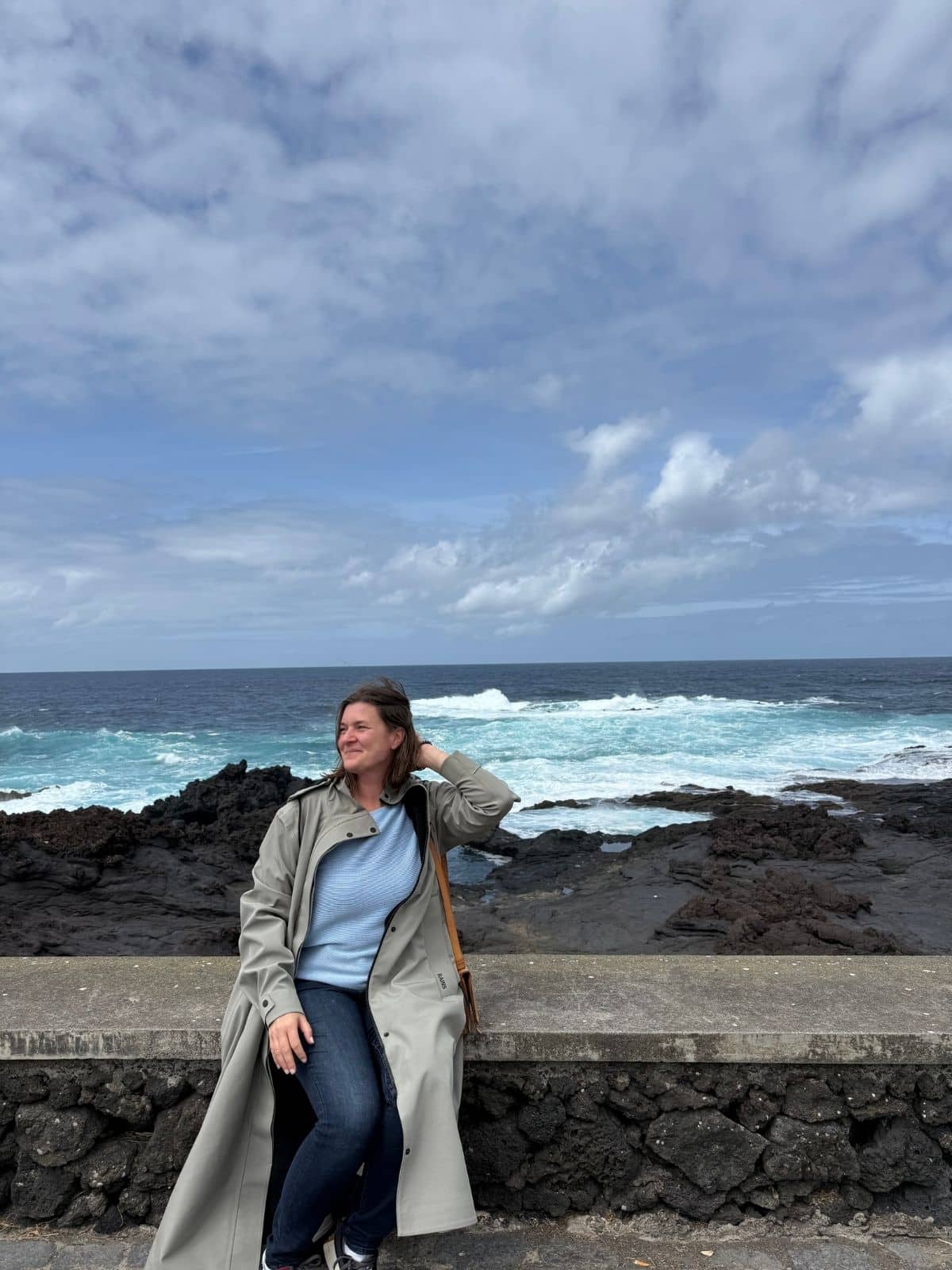 Solo traveler by rocky coastline in S&atilde;o Miguel, Azores