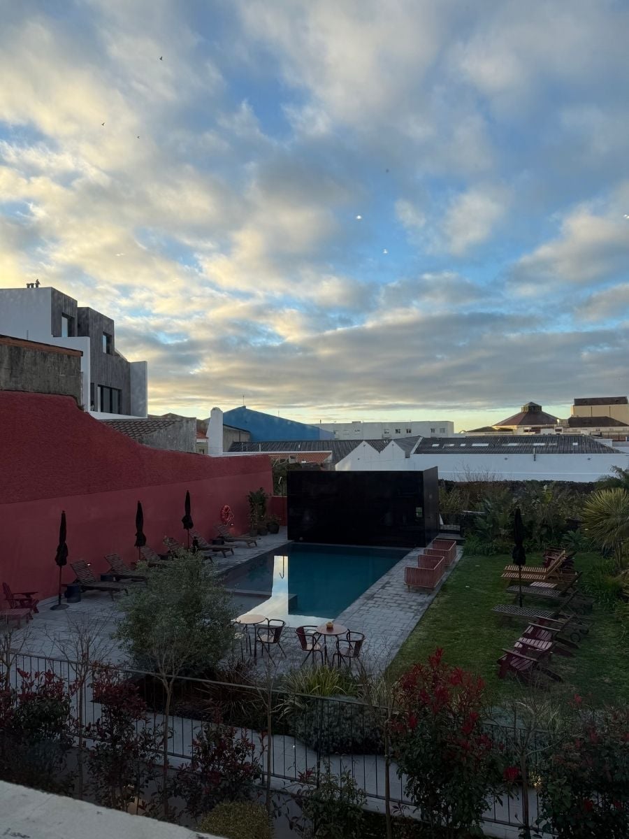 Outdoor pool area at sunset with lounge chairs and modern design at The Farm Azores Boutique House in S&atilde;o Miguel, Azores