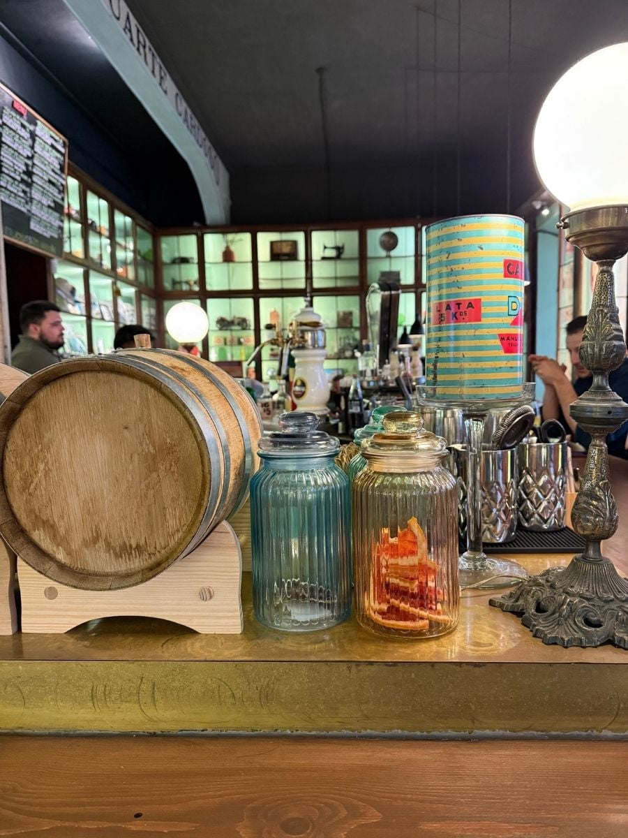 Cozy bar interior with vintage decor, glass jars, and wooden counter in S&atilde;o Miguel, Azores creating a warm, nostalgic atmosphere