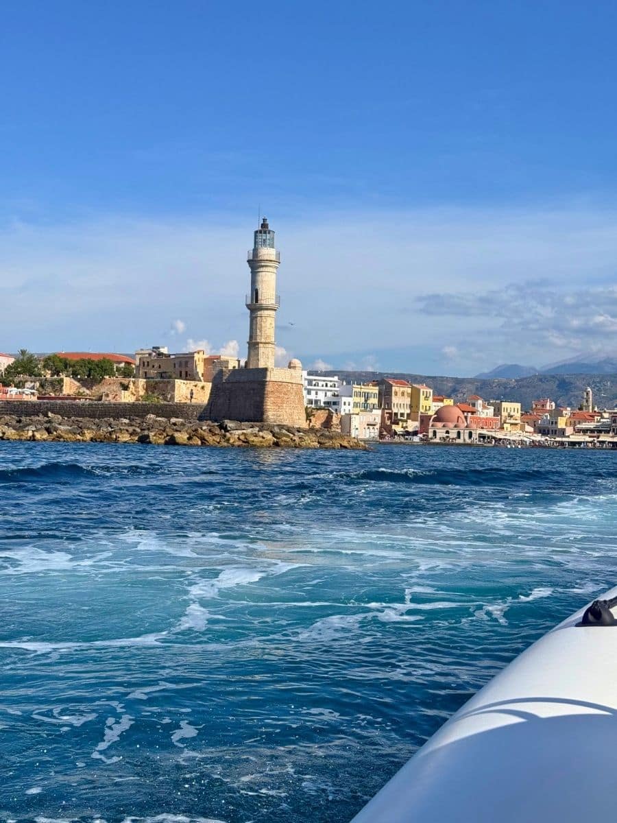 The Venetian Lighthouse standing at the entrance of Chania Old Harbor, Crete, viewed from a boat on the sea.