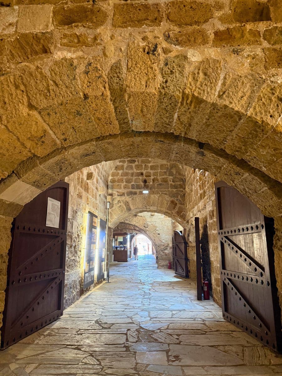 Stone archway and historic corridor inside the Koules Fortress overlooking Heraklion's Venetian harbor in Crete.