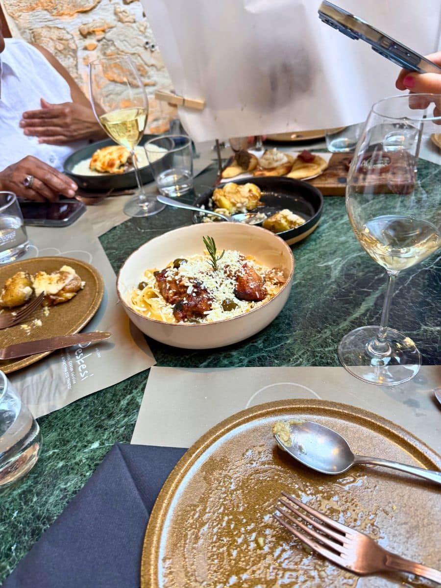 Authentic Cretan cuisine served at Peskesi restaurant in Heraklion, featuring local dishes and wine in an elegant dining setting.