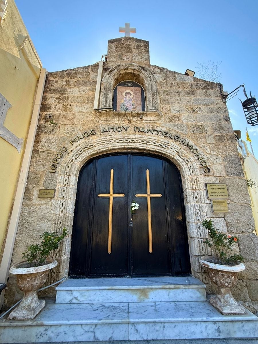 Historic Church of Saint Panteleimon with carved stone entrance and black doors in Rhodes Old Town, Rhodes, Greece.